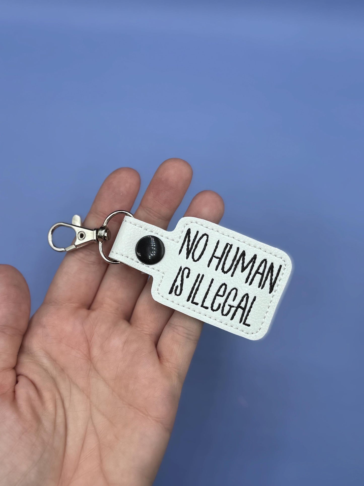 No Human Is Illegal keychain snap tab