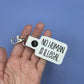 No Human Is Illegal keychain snap tab