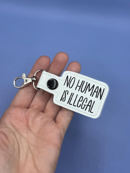 No Human Is Illegal keychain snap tab